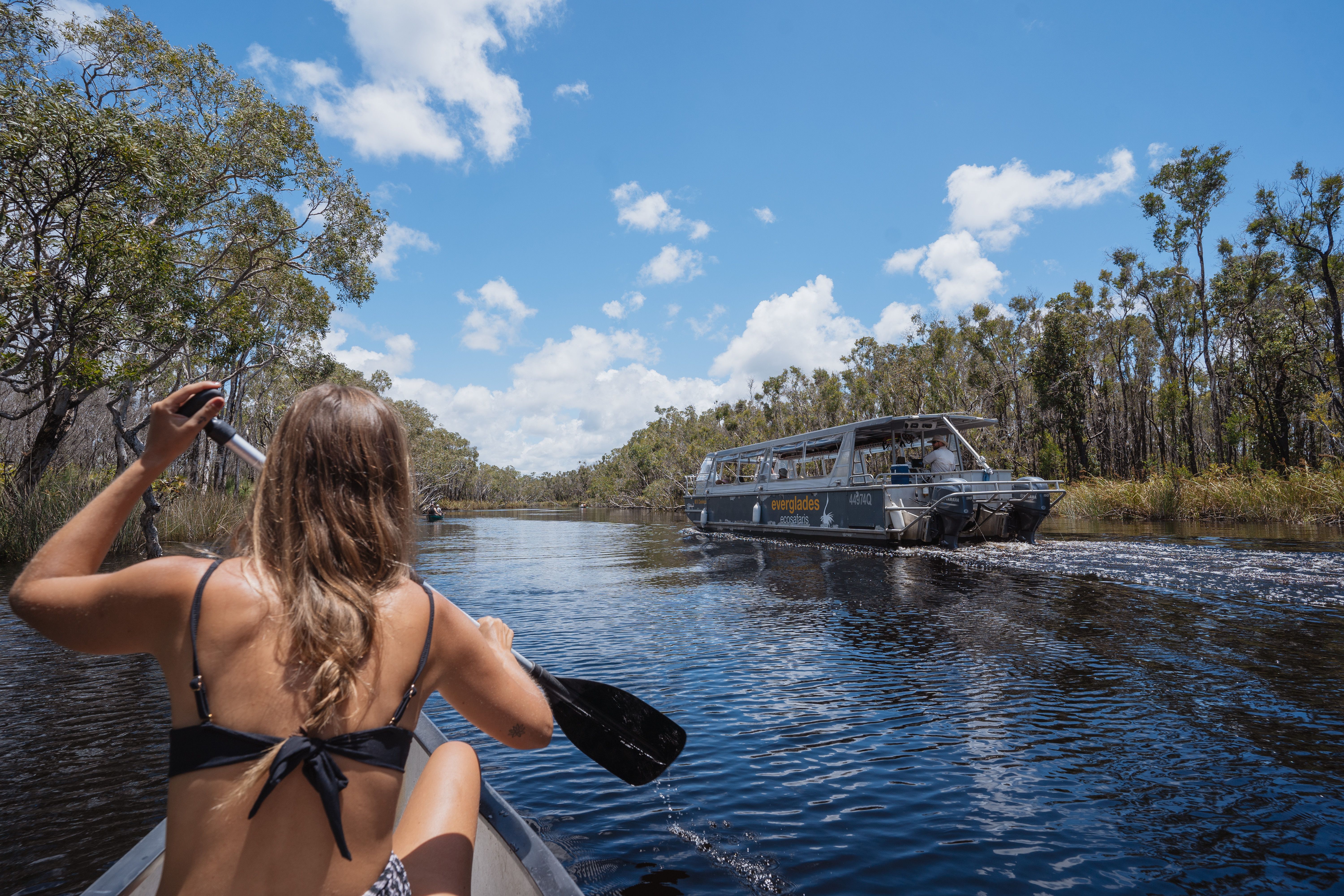 Girl In Canoe And Boat In Background